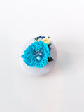 Decorative turquoise flower brooch on grey background