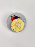 Decorative yellow flower brooch on grey background