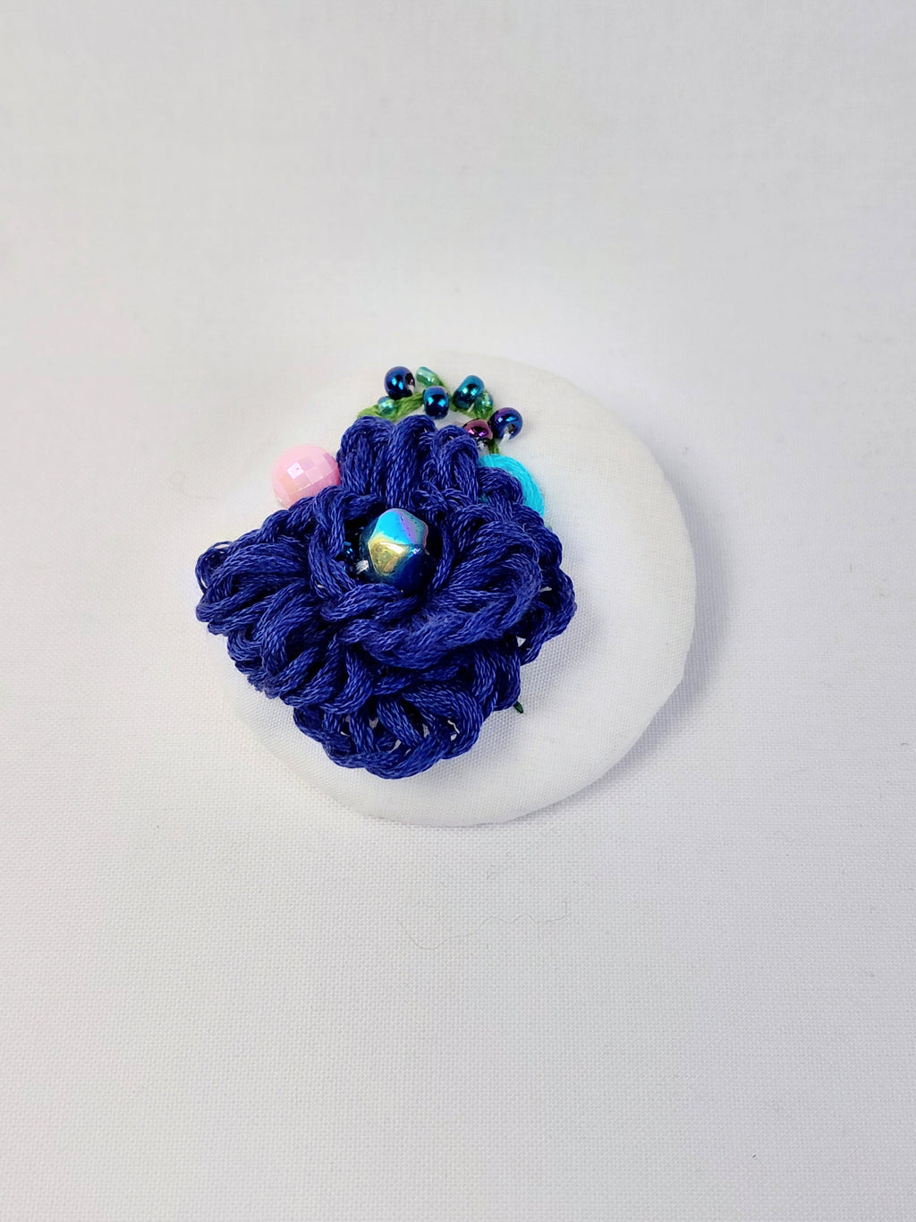 Decorative blue flower brooch on white  background