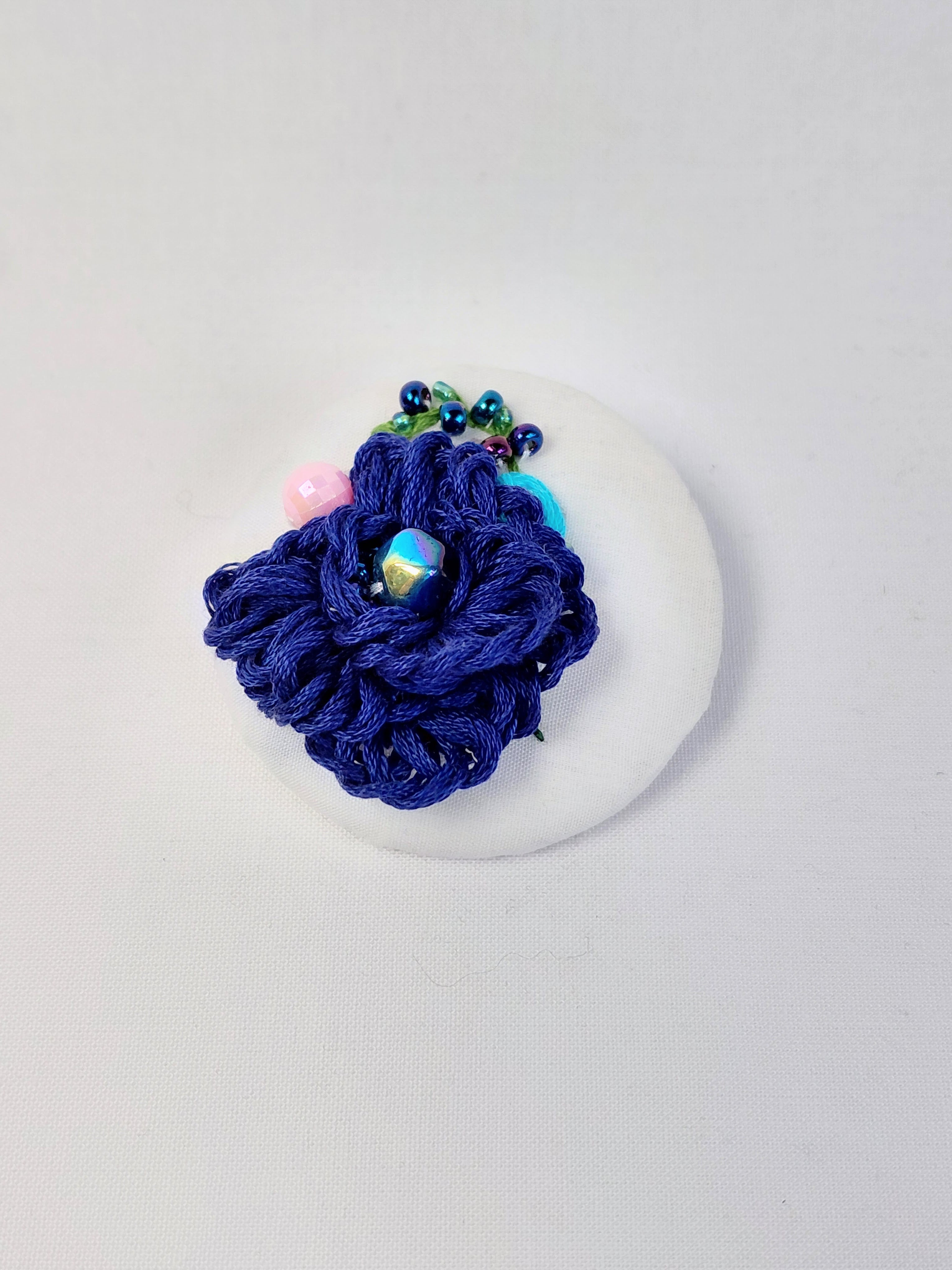 Decorative blue flower brooch on white  background