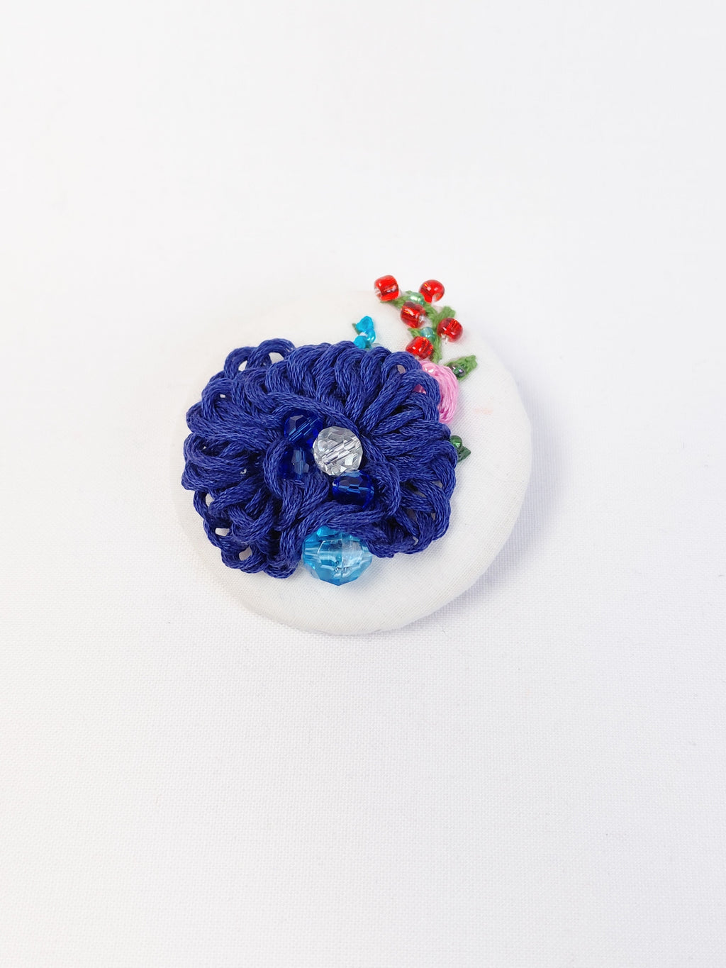 Decorative blue flower brooch on white  background