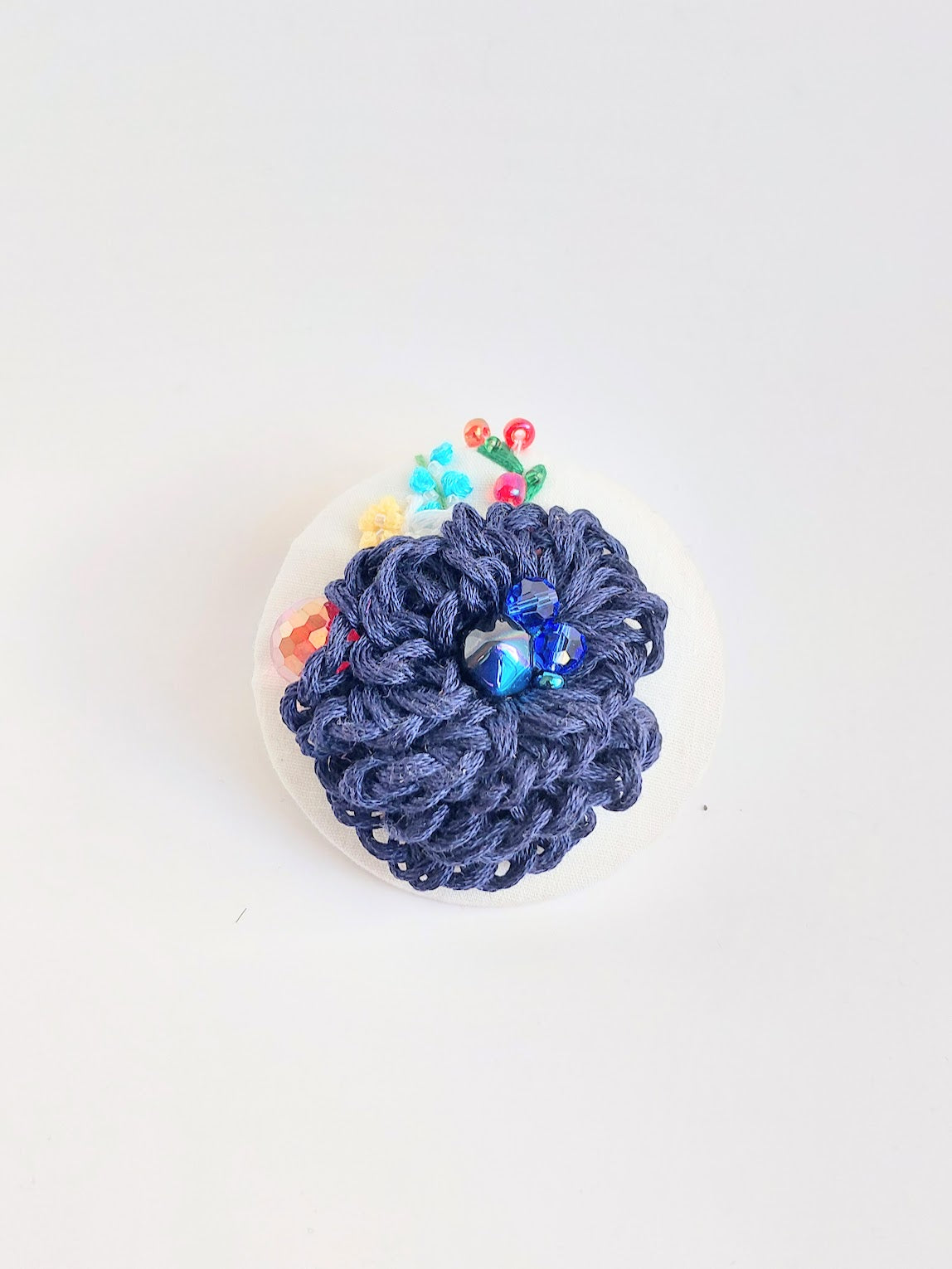 Decorative blue flower brooch on white  background