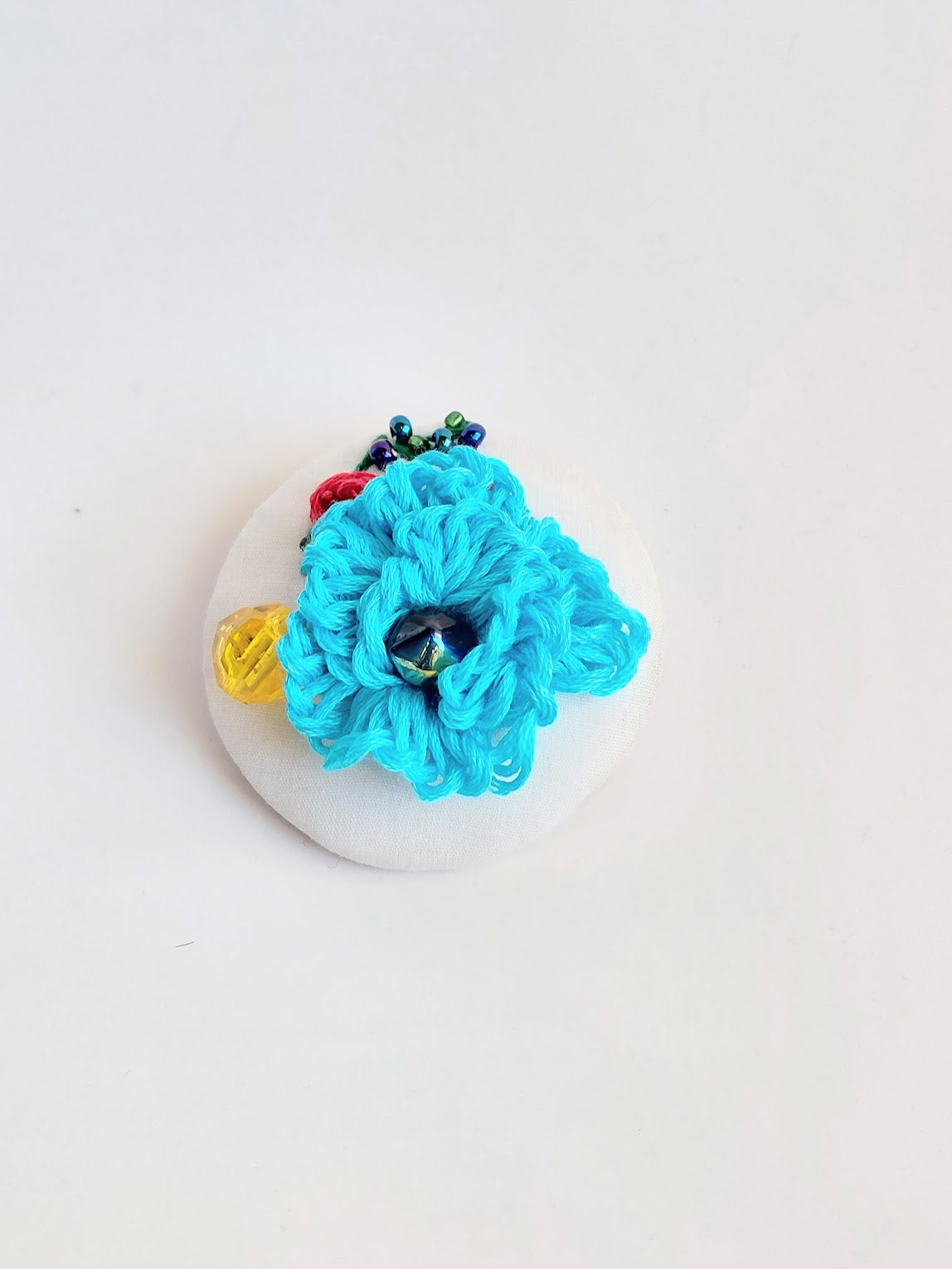 Decorative turquoise flower brooch on white  background