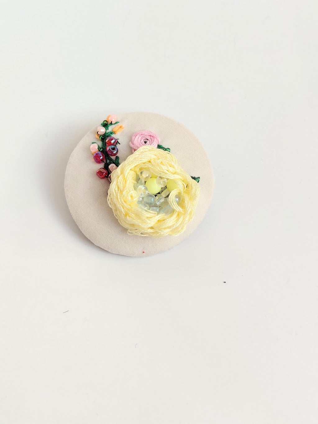 Decorative yellow flower brooch on cream  background