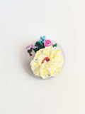 Decorative yellow flower brooch on grey  background