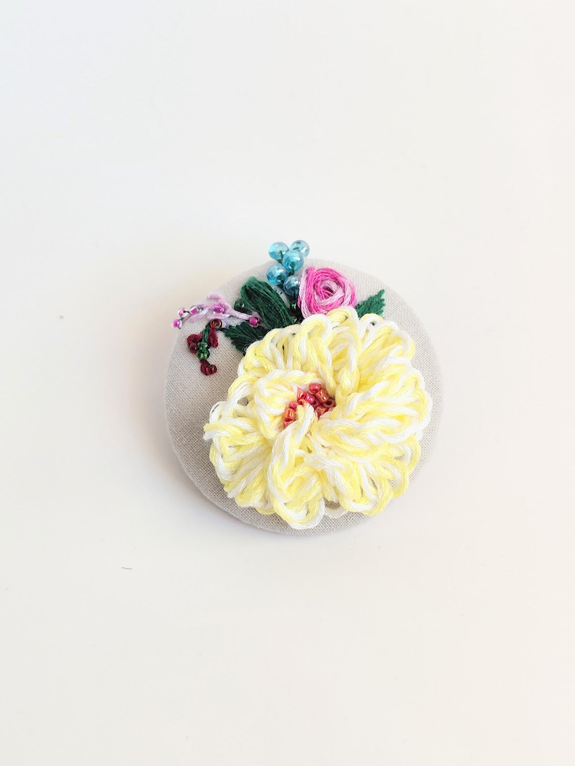 Decorative yellow flower brooch on grey  background