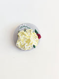 Decorative yellow flower brooch on grey background